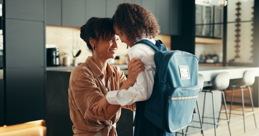 A mother and daughter walking to school together