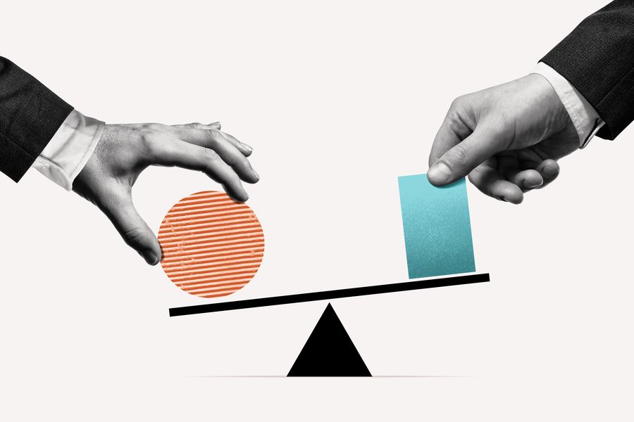 Two hands placing objects on either side of a balance scale