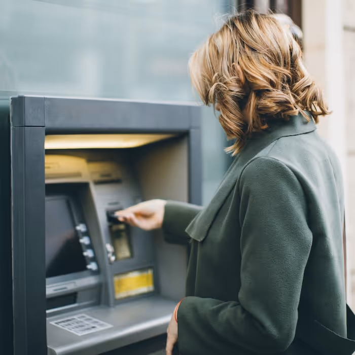 A person withdrawing cash at an ATM