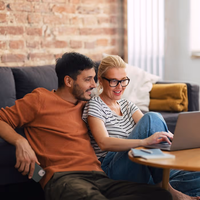 A couple looking at a laptop together